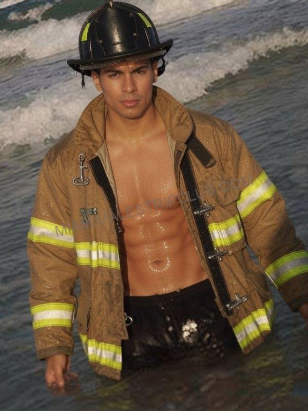 Miami male dancer JD in a firefighter costume in the surf